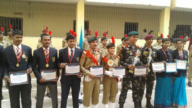 Students at an award ceremony with medals and certificates