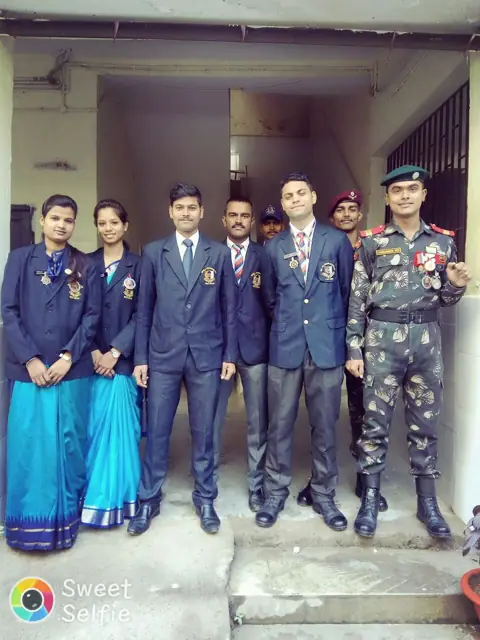 Students in blazers with medals